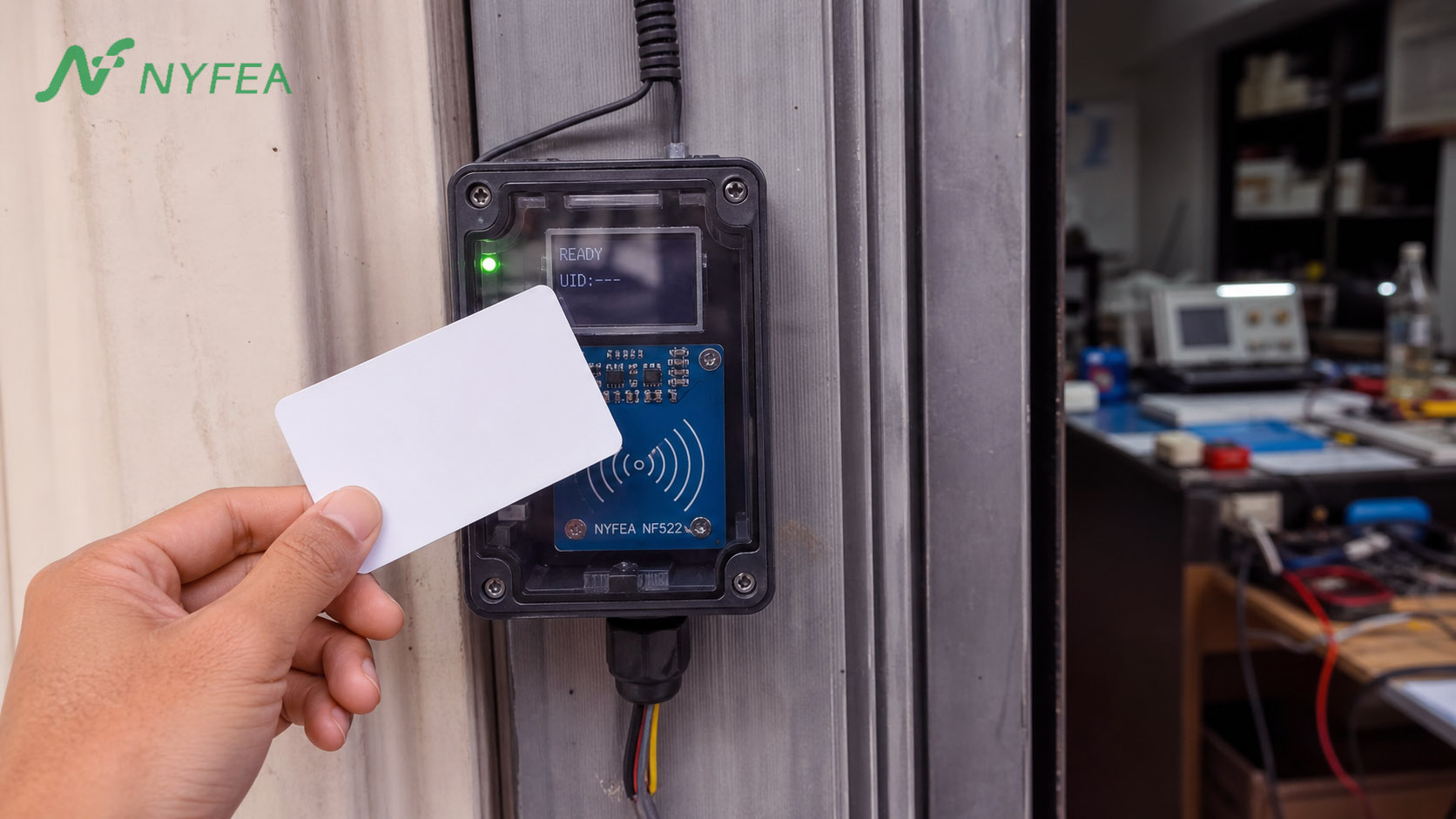 Engineer testing a NYFEA NF522 RFID reader prototype with a microcontroller, breadboard and contactless card